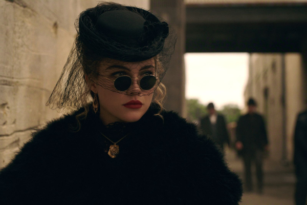 Florence Pugh as Cathy Ames in episode 106 of East of Eden wearing a black hat black sunglasses red lipstick and a...